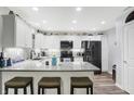 Modern kitchen featuring granite countertops, white cabinets, and stainless steel appliances at 400 E Charter Dr, Muncie, IN 47303