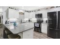 Stylish kitchen with white cabinetry, granite counters, and stainless steel appliances at 400 E Charter Dr, Muncie, IN 47303