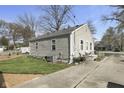 Side view of home with a well maintained green lawn and back patio set at 413 Vasbinder Dr, Anderson, IN 46017