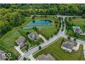 Stunning aerial view of a neighborhood with mature trees, ponds, and luxury homes on expansive lots at 4707 Branch View Way, Indianapolis, IN 46234