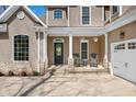 Inviting front porch featuring stone supports, a front door with wreath and two chairs at 4955 N 500 W, Columbus, IN 47201