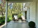 Inviting front porch with comfortable seating and beautiful views of the landscaped front yard at 5135 N Kenwood Ave, Indianapolis, IN 46208