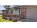 Inviting brick home with a charming front porch adorned with potted flowers at 5444 S Holiday Dr, Columbus, IN 47203