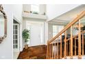 Elegant foyer with hardwood floors, soaring ceilings, and decorative staircase at 5698 Kenderly Ct, Carmel, IN 46033