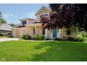 Brick home featuring a well-kept lawn, mature trees, and an inviting front porch at 6345 Canak Dr, Avon, IN 46123