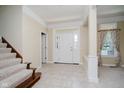 Bright and airy foyer featuring neutral tones, tile flooring, and staircase at 6345 Canak Dr, Avon, IN 46123