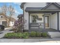 Inviting front porch with seating and blooming magnolia tree at 7371 E 100 N, Whitestown, IN 46075