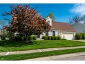Charming single-Gathering home featuring a well-manicured lawn, complementary landscaping, and a two-car garage at 8142 Bittern Ln, Indianapolis, IN 46256