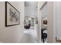 Bright hallway showcasing artwork leading to a spacious living area at 8410 Glenwillow Ln # 208, Indianapolis, IN 46278