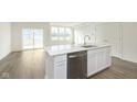 Modern kitchen features a white center island, stainless steel dishwasher, and an open floorplan at 9734 Behner Dr, Fishers, IN 46250