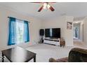 The large living room is open and bright, and features neutral carpet and ample natural light at 1040 Iowa St, Columbus, IN 47201