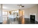 Open concept living room featuring hardwood floors, a fireplace, and seamless access to the kitchen at 10448 Pintail Ln, Indianapolis, IN 46239