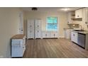 Eat-in kitchen featuring modern cabinets, new flooring, and a window over the sink at 107 N Grant St, Brownsburg, IN 46112