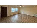 Bright living room featuring new flooring, fresh paint, and double windows offering natural light at 107 N Grant St, Brownsburg, IN 46112