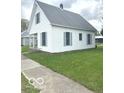Classic home showcasing a neat yard, offering a blend of comfort and traditional design at 11 W Osage St, Greenfield, IN 46140