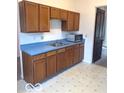 Functional kitchen featuring ample wooden cabinets, blue countertops, and essential appliances at 11 W Osage St, Greenfield, IN 46140