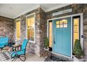 Charming front entrance with stone accents and a bright teal colored door at 1295 Clairet Dr, Westfield, IN 46074