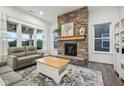 Inviting living room with a stone fireplace and large windows for natural light at 1295 Clairet Dr, Westfield, IN 46074