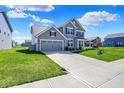 Attractive home with a two-car garage, well-kept lawn and extended driveway at 12951 Corydon Dr, Fishers, IN 46037