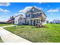 Inviting two-story home with lush green lawn, driveway, and a welcoming front entrance at 12951 Corydon Dr, Fishers, IN 46037