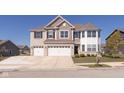 Two-story home with a three car garage, brick accents and manicured lawn at 1370 Timber Bluff Rd, Westfield, IN 46074