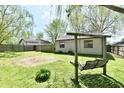 Spacious backyard featuring a swing set and a mix of grassy and gravel areas at 1472 Maria Ave, Franklin, IN 46131