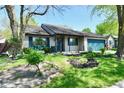 Charming single-story home with a well-maintained front yard, blue shutters, and an attached garage at 1472 Maria Ave, Franklin, IN 46131