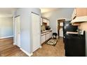Functional kitchen featuring white cabinets, essential appliances, and easy access to the laundry area at 1472 Maria Ave, Franklin, IN 46131