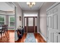Bright foyer with hardwood floors, decorative front door, and view into the dining room at 1510 Central Ave, Indianapolis, IN 46202
