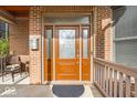 Elegant front door with decorative glass, brick wall and a black welcome mat at 1510 Central Ave, Indianapolis, IN 46202