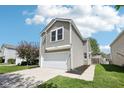 Attractive two-story home with a cozy feel, featuring an attached garage and green lawn at 16780 Lowell Dr, Noblesville, IN 46060