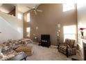 Bright living room with soaring ceilings, neutral paint, plush carpet, and an abundance of natural light at 1884 Misty Lake Dr, Indianapolis, IN 46260
