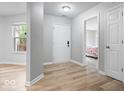 Inviting entryway with wood-look flooring, neutral walls, and views to adjacent rooms at 19516 Golden Meadow Way, Noblesville, IN 46060