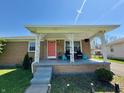 Inviting front porch with seating area, perfect for relaxing and enjoying the neighborhood views at 2143 N Graham Ave, Indianapolis, IN 46218