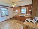 Traditional kitchen featuring wooden cabinetry, vintage appliances, and a window at 2309 Pennsylvania St, Columbus, IN 47201