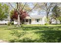 Lovely single-Gathering home with a green lawn and mature trees showcasing classic suburban living at 233 N Fenton Ave, Indianapolis, IN 46219