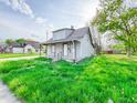 A cozy two-story home with a covered porch and inviting curb appeal at 274 Leeds Ave, Indianapolis, IN 46201