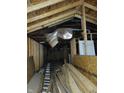 Unfinished attic space with exposed wooden beams, framing, and insulation at 3123 S Rybolt Ave, Indianapolis, IN 46241