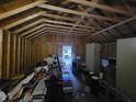 Unfinished garage interior with exposed wooden beams and ample storage space at 3123 S Rybolt Ave, Indianapolis, IN 46241