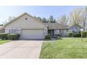 Charming single-story home with a well-manicured lawn and a two-car garage, showcasing curb appeal at 3427 Brunswick Ave, Indianapolis, IN 46227