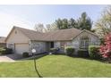 Beautiful single-story home with a manicured lawn, mature trees and a brick facade at 3427 Brunswick Ave, Indianapolis, IN 46227
