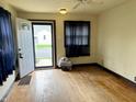 A bright room featuring hardwood floors and a view through the front door to the outside at 3434 Forrest Ter, Anderson SE, IN 46013