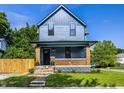 Charming two-story home featuring a covered front porch with brick supports and a well-maintained lawn at 3868 N Park Ave, Indianapolis, IN 46205