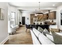 Bright and airy living room seamlessly connected to the dining area and modern kitchen at 3868 N Park Ave, Indianapolis, IN 46205