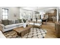 Open-concept living room featuring stylish furniture, hardwood floors, and ample natural light at 3868 N Park Ave, Indianapolis, IN 46205