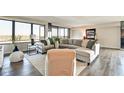 Spacious living room with large windows, stylish furniture, and hardwood flooring at 4000 N Meridian St # Apt 15J, Indianapolis, IN 46208