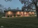 Inviting single-story brick home featuring a lush green lawn and professionally maintained landscaping at 4037 Hazy Ln, Greenwood, IN 46142