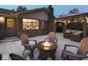 Outdoor patio area features a gas fire pit, with plenty of seating, and overhead pergola at 4037 Hazy Ln, Greenwood, IN 46142