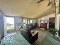 Comfortable living room with reclining leather sofas, a large rug, and natural light from the windows at 4726 Breckenridge Dr, Columbus, IN 47203