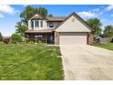 Two-story home featuring a two-car garage, well-maintained lawn, and charming curb appeal at 500 Meadowlark Ct, Whiteland, IN 46184